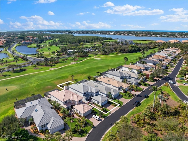 drone / aerial view featuring a water view, a residential view, and golf course view