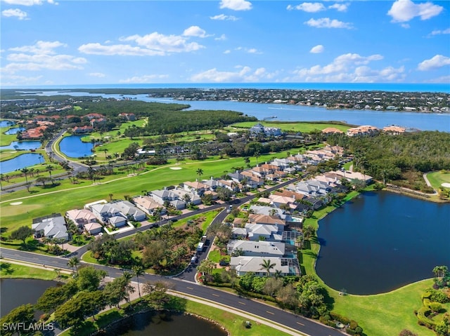 birds eye view of property with golf course view, a water view, and a residential view