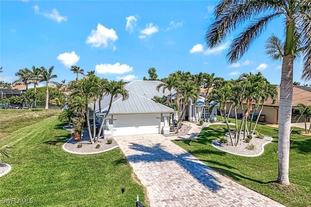 2345 SW 28th Ter, Cape Coral, FL 33914 - view of front of house with driveway, a front yard, and a garage
