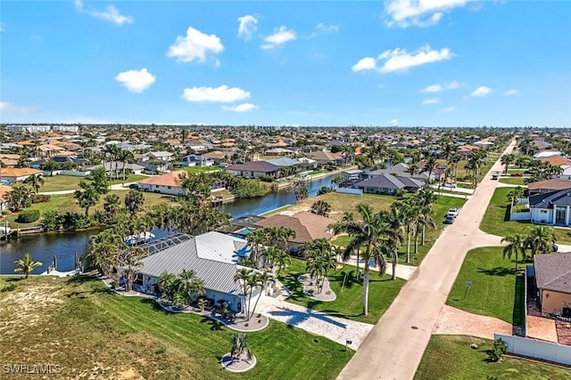 drone / aerial view with a water view and a residential view