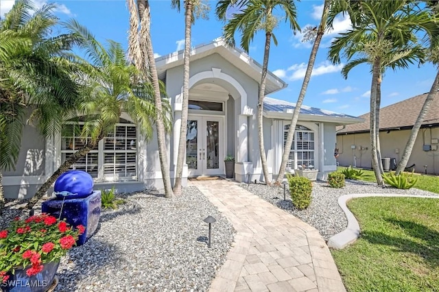 exterior space featuring french doors and stucco siding