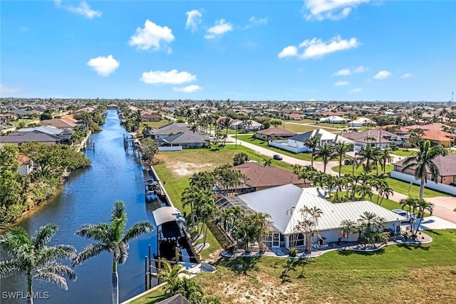 birds eye view of property with a water view and a residential view