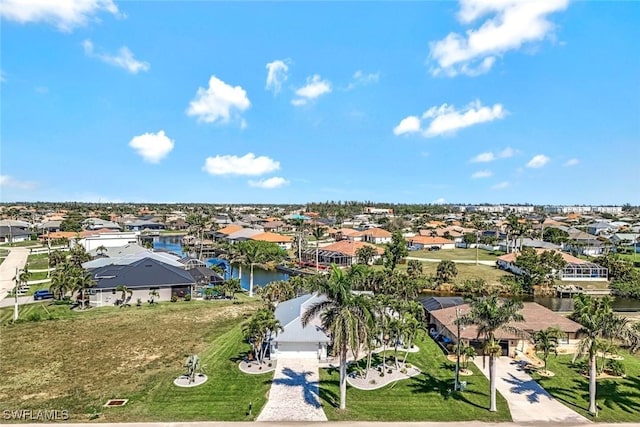 drone / aerial view featuring a water view and a residential view