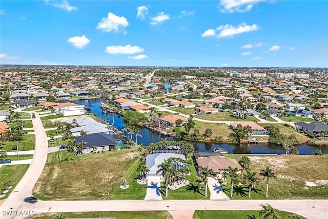 bird's eye view featuring a water view and a residential view