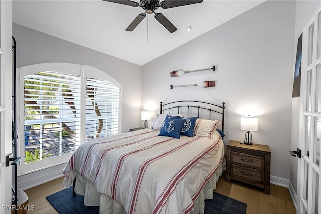 bedroom featuring lofted ceiling, ceiling fan, baseboards, and wood finished floors