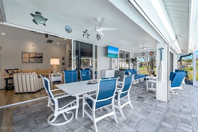 view of patio featuring ceiling fan, visible vents, outdoor dining area, and an outdoor living space