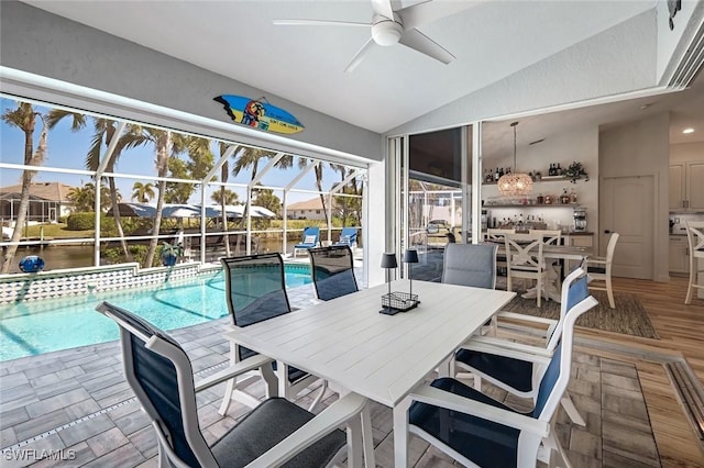 pool with outdoor dining space, a lanai, a patio, and ceiling fan