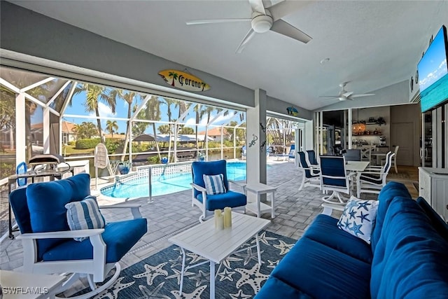 interior space with an outdoor hangout area, glass enclosure, a ceiling fan, and an outdoor pool