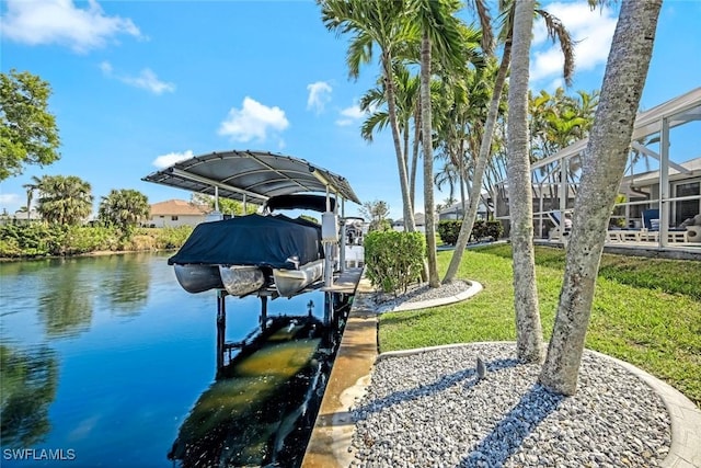 dock area featuring a lanai, a water view, a lawn, and boat lift