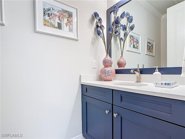 bathroom featuring crown molding and vanity