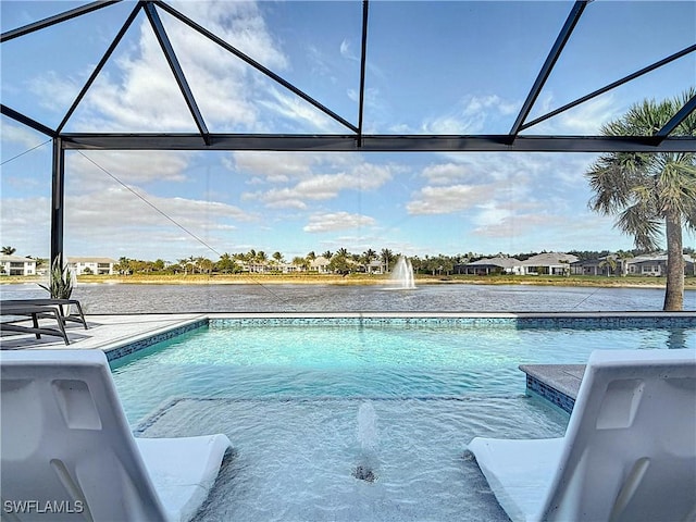 view of swimming pool featuring glass enclosure