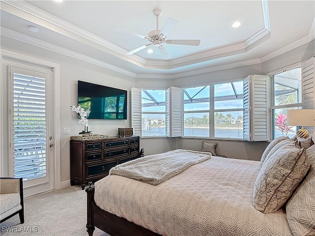 carpeted bedroom featuring ornamental molding, recessed lighting, a raised ceiling, and a ceiling fan