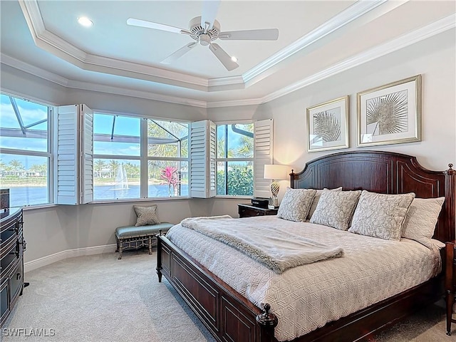 bedroom with ornamental molding, a raised ceiling, light carpet, and baseboards