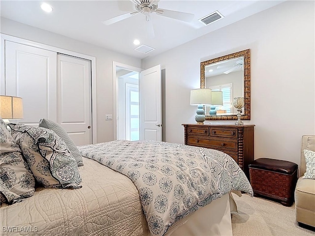 carpeted bedroom featuring a closet, recessed lighting, visible vents, and a ceiling fan