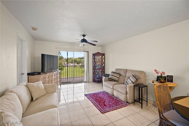 living area featuring light tile patterned floors and ceiling fan