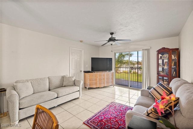 living area with light tile patterned flooring and a ceiling fan