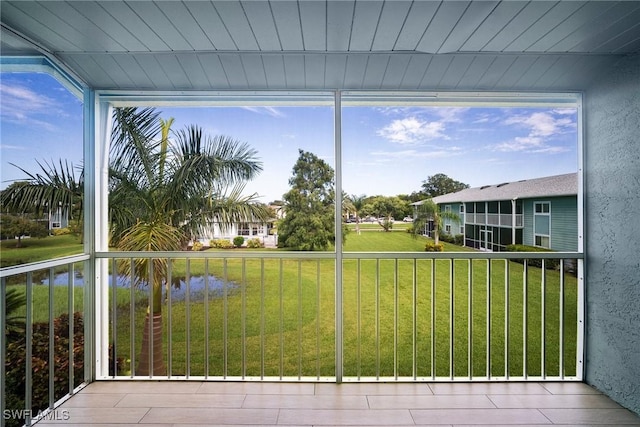 unfurnished sunroom with a water view