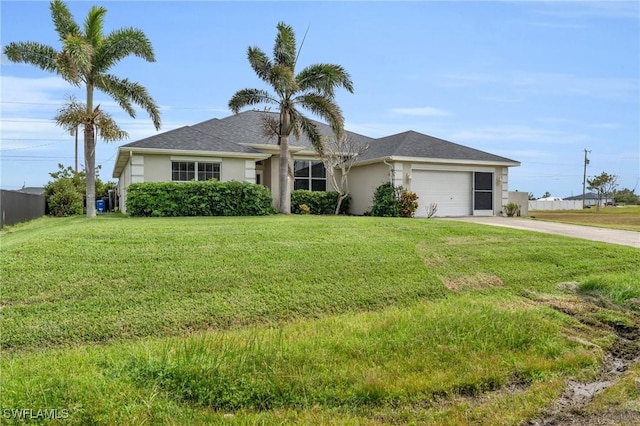 ranch-style home with driveway, a front yard, an attached garage, and stucco siding