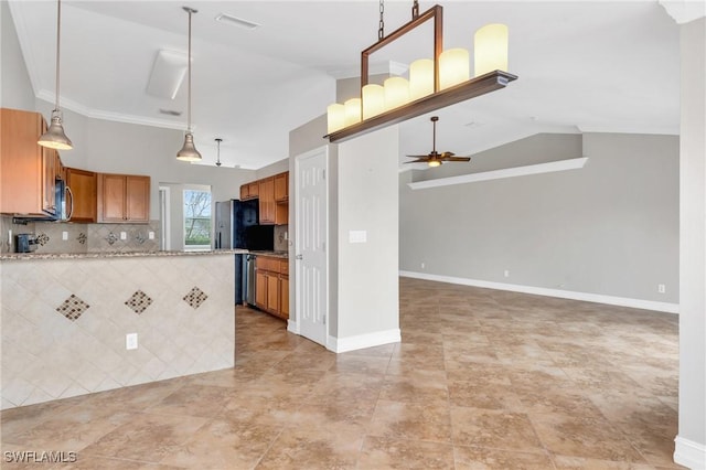 kitchen featuring tasteful backsplash, lofted ceiling, stainless steel microwave, brown cabinetry, and a ceiling fan