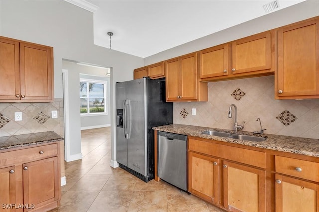 kitchen with dark stone counters, stainless steel appliances, a sink, and visible vents