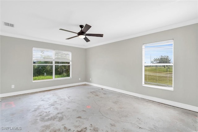 empty room featuring baseboards, unfinished concrete flooring, and a wealth of natural light