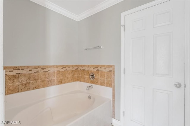 bathroom with crown molding and a bath