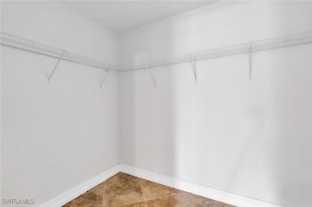 spacious closet with tile patterned flooring