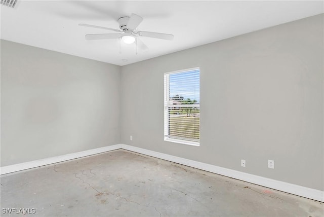 unfurnished room with a ceiling fan, visible vents, baseboards, and unfinished concrete flooring