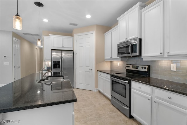 kitchen featuring visible vents, white cabinets, appliances with stainless steel finishes, a sink, and backsplash