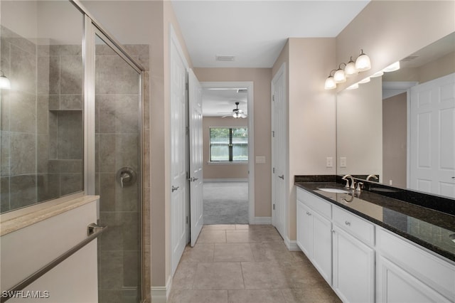 full bathroom featuring a stall shower, visible vents, baseboards, tile patterned flooring, and vanity