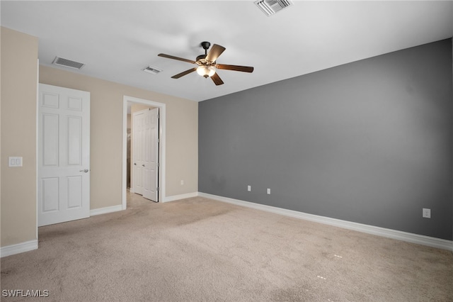 unfurnished bedroom featuring visible vents, light carpet, and baseboards