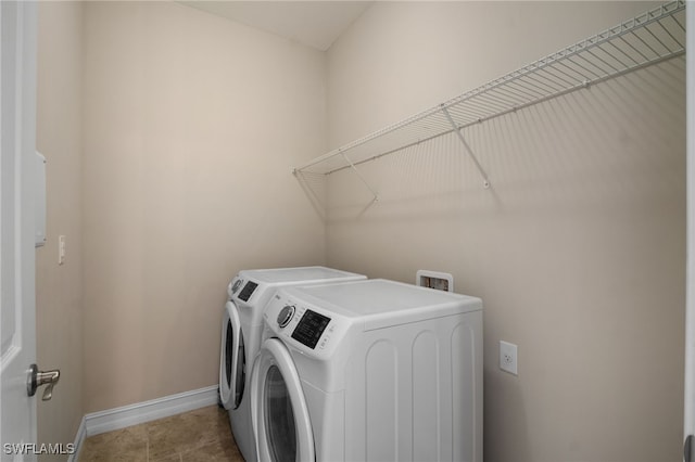 laundry room with baseboards, laundry area, washing machine and dryer, and tile patterned floors