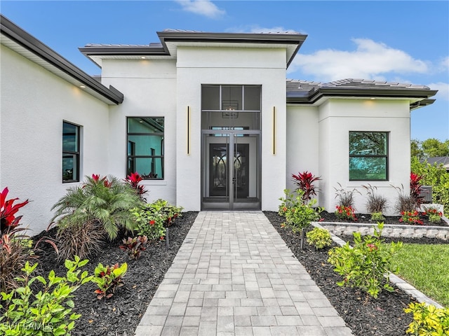 property entrance with stucco siding