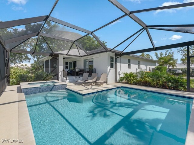 view of swimming pool featuring a pool with connected hot tub and a patio