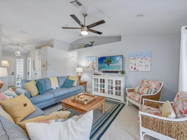 living area with lofted ceiling, visible vents, and ceiling fan