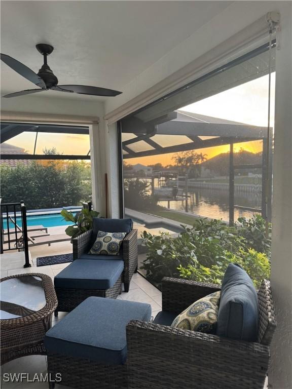 sunroom featuring a ceiling fan