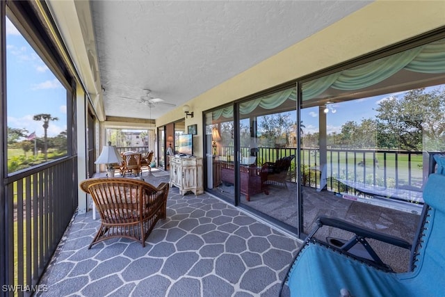 sunroom with a ceiling fan