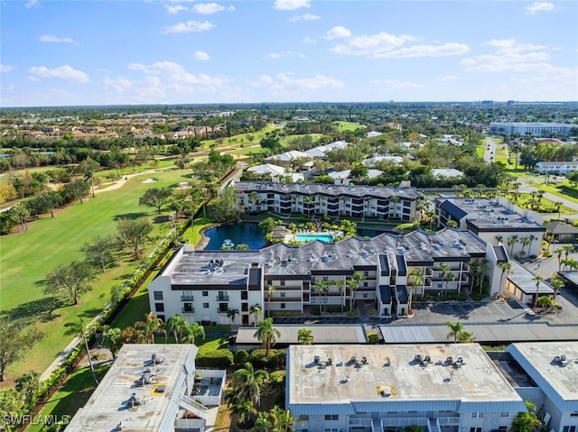 birds eye view of property with golf course view and a water view