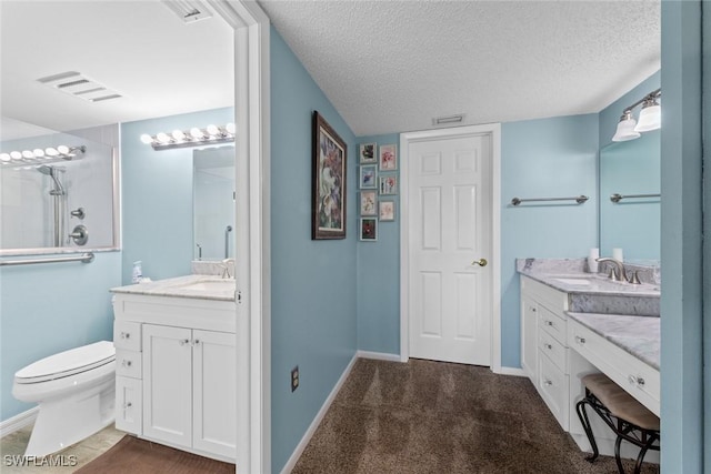 full bathroom with visible vents, baseboards, two vanities, a textured ceiling, and a sink