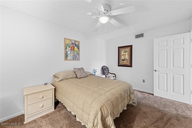 carpeted bedroom featuring baseboards, visible vents, and ceiling fan