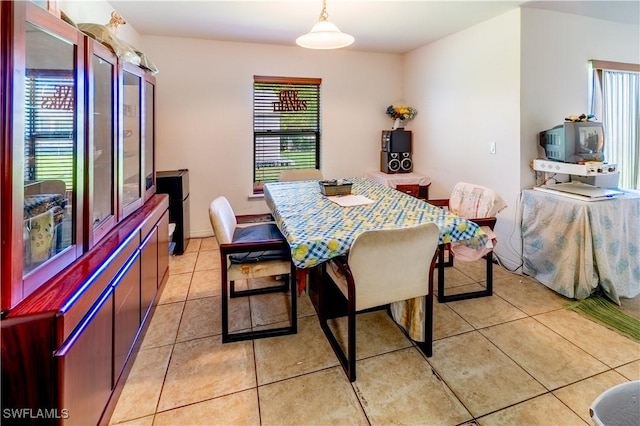 dining space featuring light tile patterned flooring