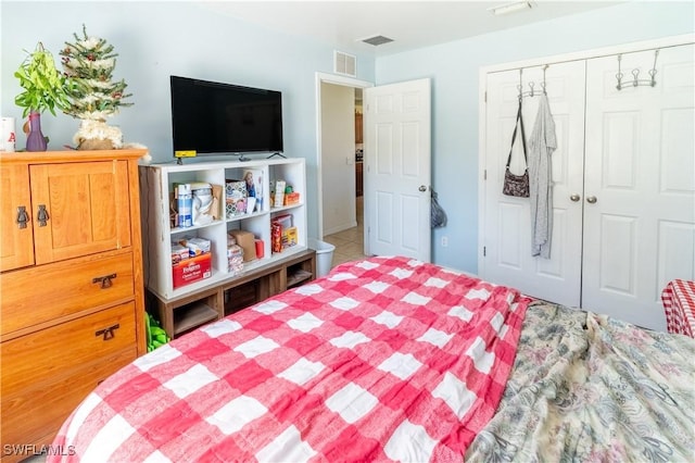 bedroom with a closet and visible vents