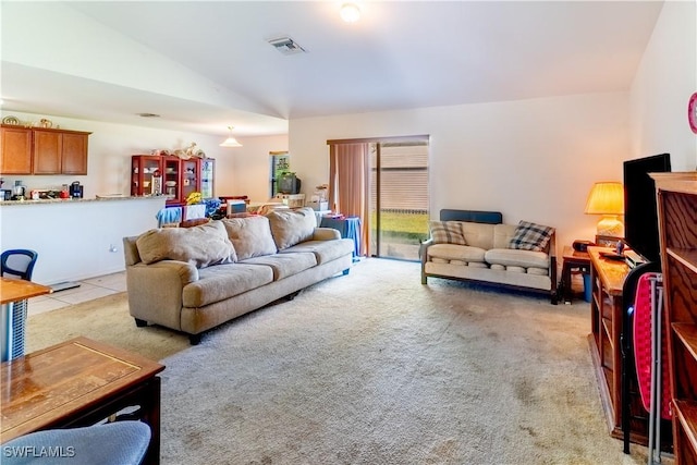 living area with vaulted ceiling, light tile patterned floors, light carpet, and visible vents