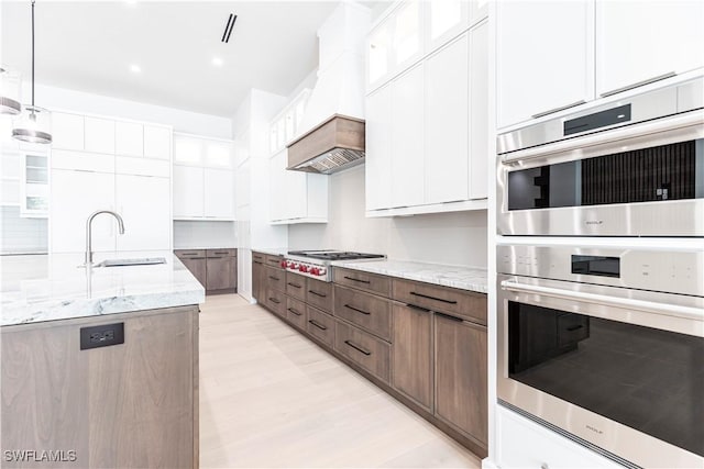 770 Port Side Dr, Naples, FL 34103 - kitchen with appliances with stainless steel finishes, white cabinetry, light stone countertops, pendant lighting, and recessed lighting