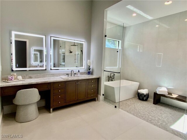 770 Port Side Dr, Naples, FL 34103 - bathroom featuring a soaking tub, vanity, and tile patterned floors