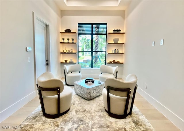 770 Port Side Dr, Naples, FL 34103 - sitting room with light wood-style floors and a tray ceiling