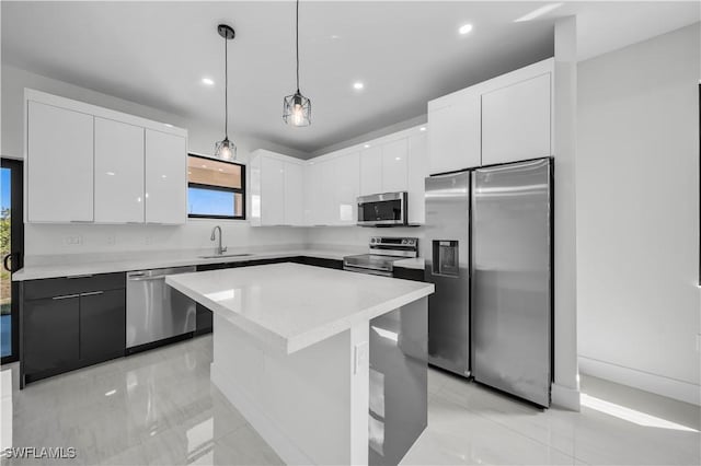 kitchen featuring white cabinets, modern cabinets, stainless steel appliances, and a sink