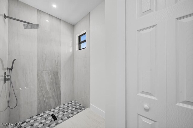 bathroom with tiled shower