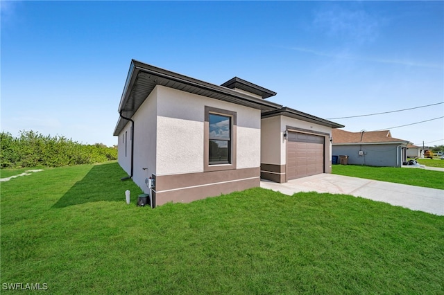 view of front of property featuring a garage, concrete driveway, a front yard, and stucco siding