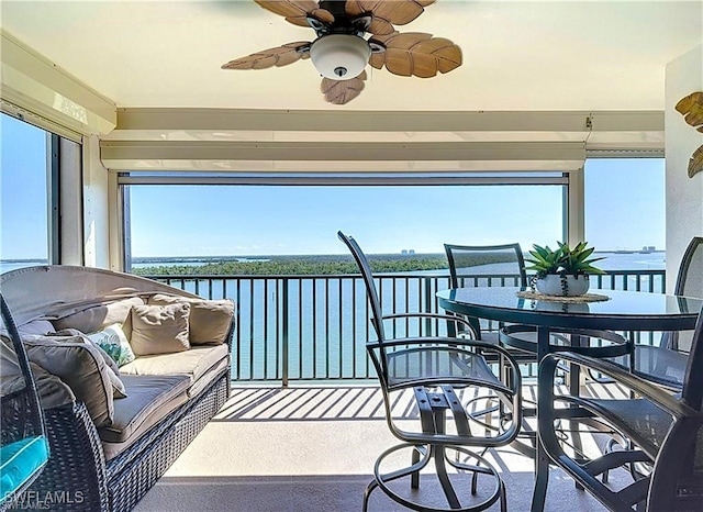 sunroom / solarium with a water view